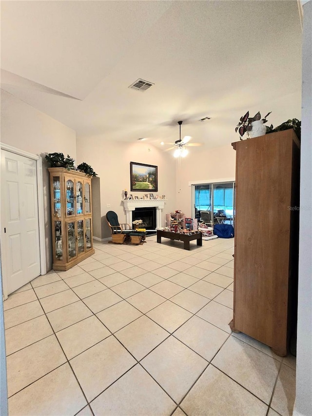 tiled living room featuring ceiling fan