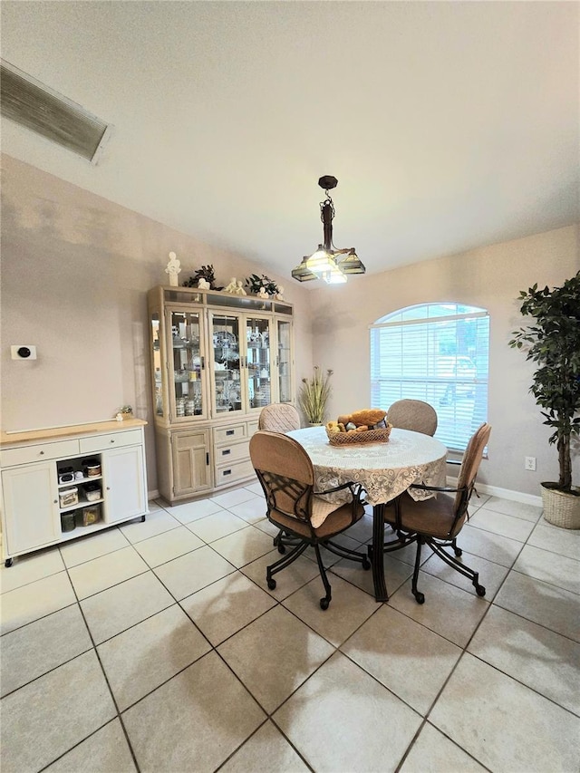 tiled dining area featuring lofted ceiling