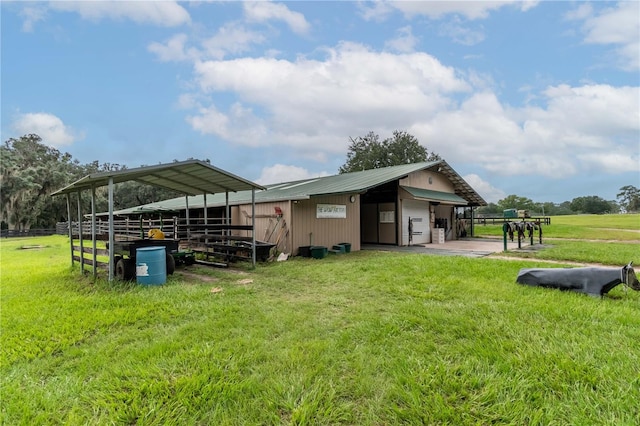 exterior space with an outdoor structure and a rural view