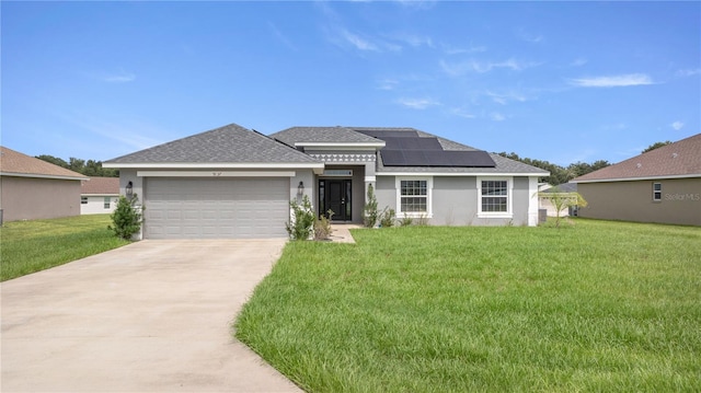 prairie-style house featuring a front yard, a garage, and solar panels