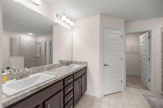 bathroom with vanity, tile patterned floors, a textured ceiling, and an enclosed shower