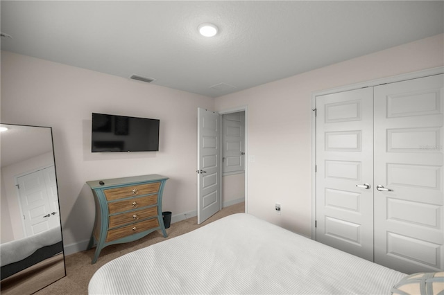 bedroom featuring a closet and light colored carpet