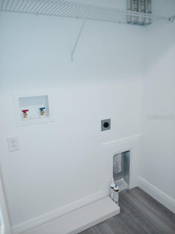 laundry room with washer hookup, wood-type flooring, and electric dryer hookup