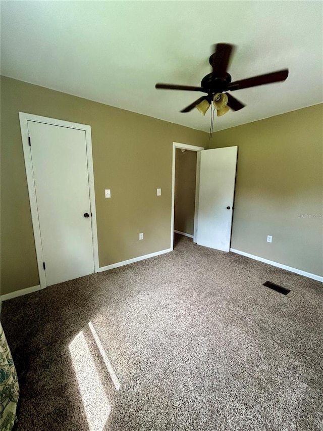 unfurnished bedroom with carpet floors and ceiling fan