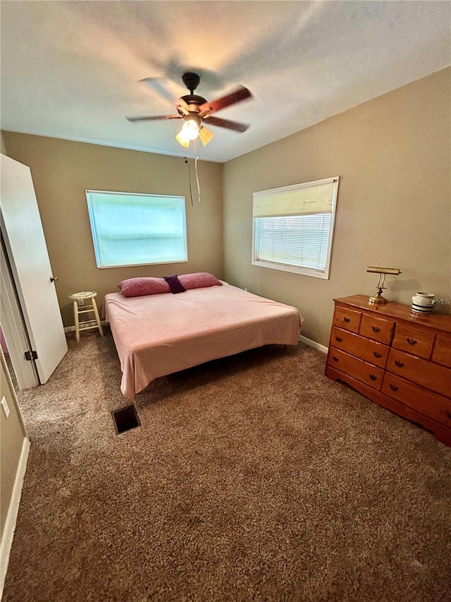 bedroom featuring dark colored carpet and ceiling fan