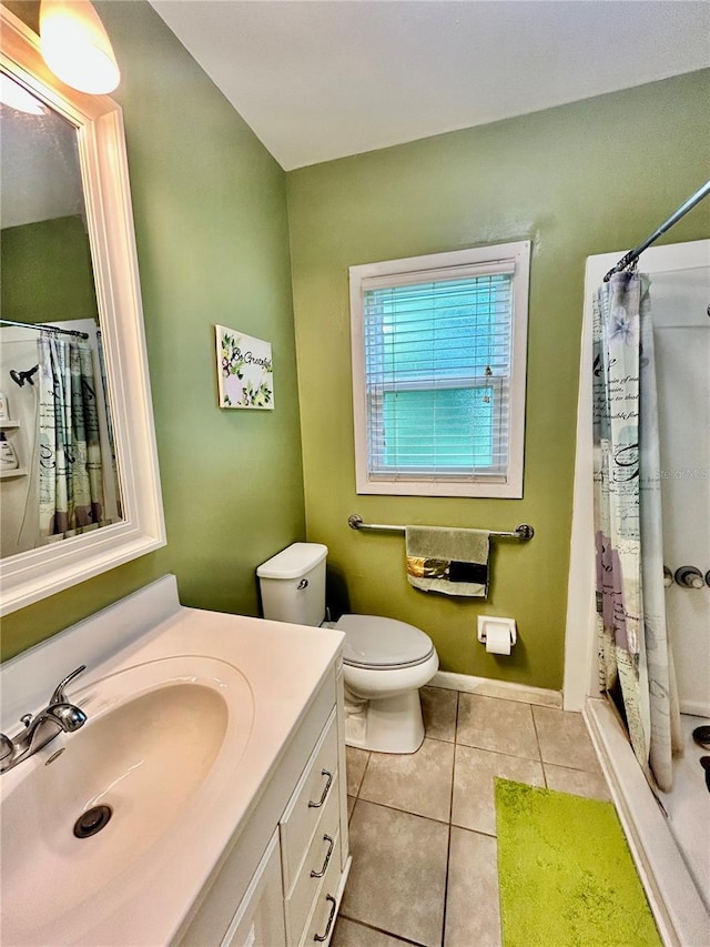 bathroom with walk in shower, vanity, toilet, and tile patterned floors