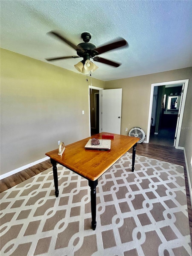 interior space with ceiling fan, hardwood / wood-style flooring, and a textured ceiling