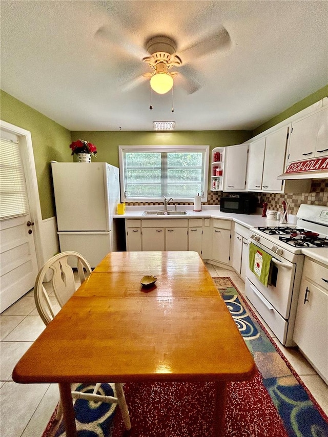 kitchen with white cabinets, white appliances, ceiling fan, and a textured ceiling