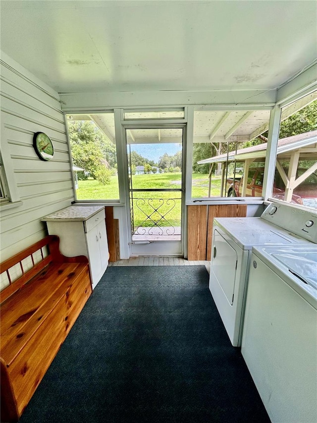 sunroom / solarium featuring independent washer and dryer and a wealth of natural light