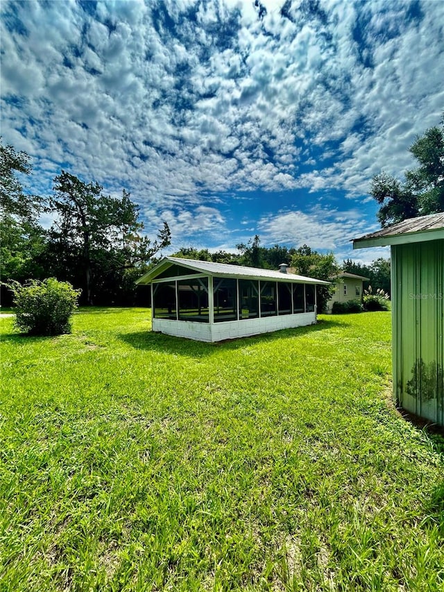 view of yard with a sunroom