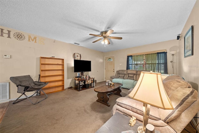 living room with ceiling fan, carpet floors, and a textured ceiling