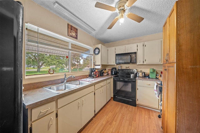 kitchen with a textured ceiling, black appliances, light wood-type flooring, ceiling fan, and sink