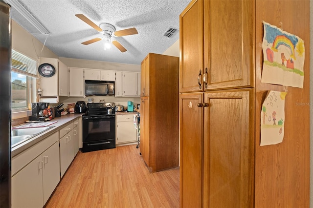 kitchen featuring ceiling fan, a textured ceiling, black appliances, white cabinetry, and light hardwood / wood-style floors