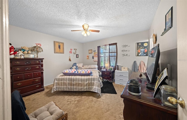 carpeted bedroom featuring ceiling fan and a textured ceiling