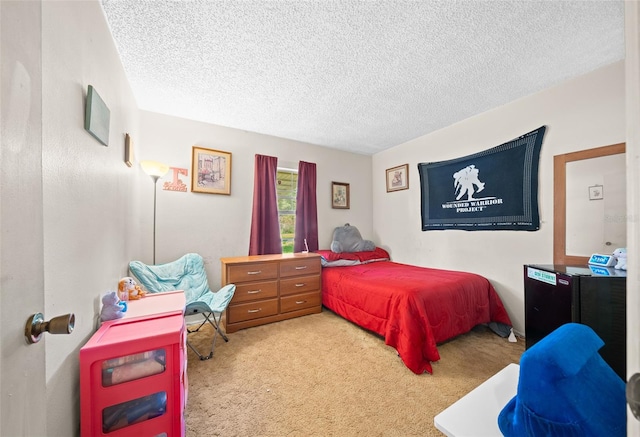 bedroom with a textured ceiling and carpet flooring