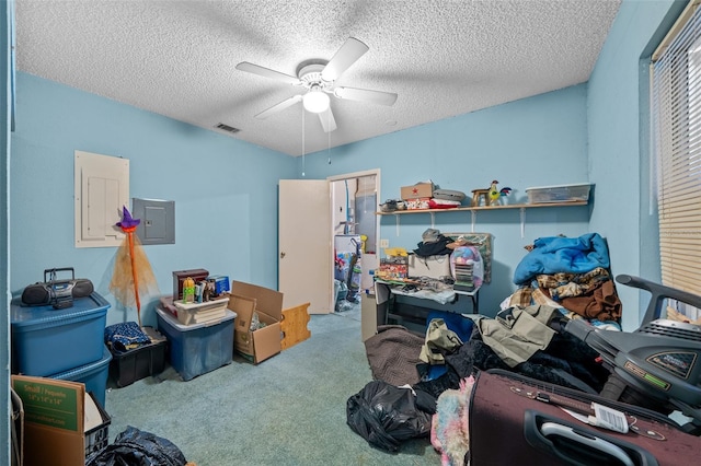 interior space with ceiling fan, carpet flooring, and a textured ceiling