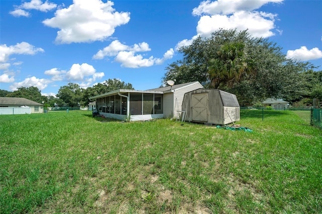 view of yard with a sunroom and a shed