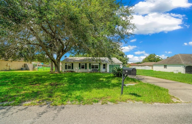 ranch-style home featuring a front yard