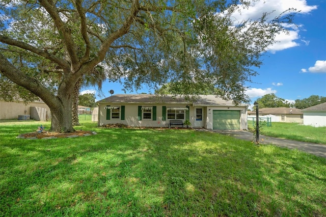 ranch-style home featuring a garage and a front yard