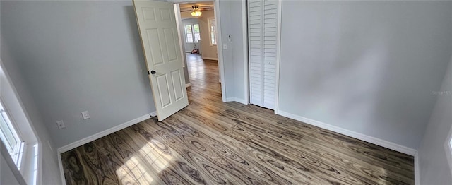 unfurnished bedroom with wood-type flooring and a closet