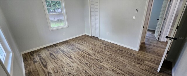 unfurnished bedroom with hardwood / wood-style flooring