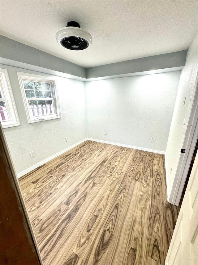 spare room featuring a textured ceiling and hardwood / wood-style floors