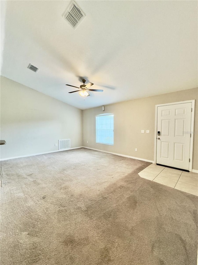 unfurnished room with light carpet, a ceiling fan, and visible vents