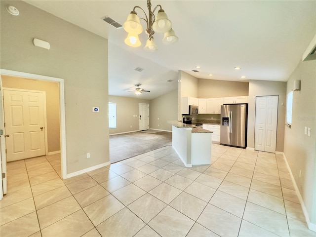 kitchen with appliances with stainless steel finishes, light tile patterned flooring, white cabinetry, light stone counters, and pendant lighting