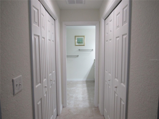 corridor with light tile patterned floors