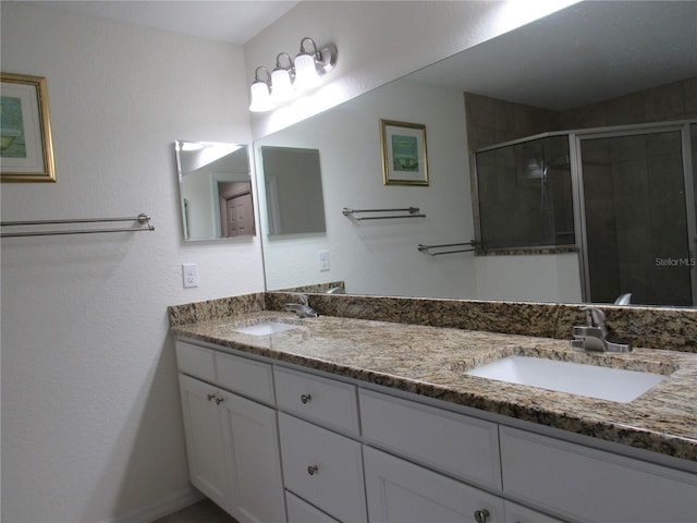 bathroom with vanity and a shower with shower door