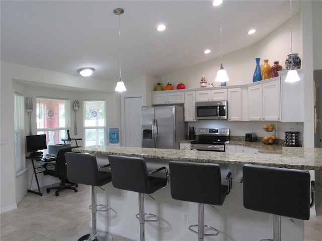 kitchen with light stone counters, stainless steel appliances, decorative light fixtures, white cabinets, and lofted ceiling