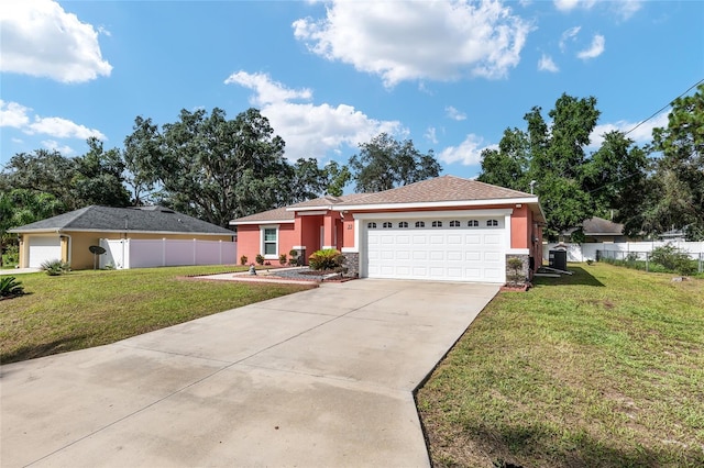 ranch-style home featuring a garage and a front lawn