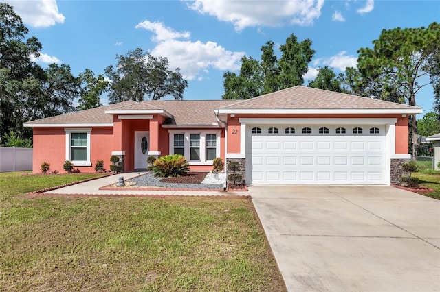 single story home with a garage and a front lawn