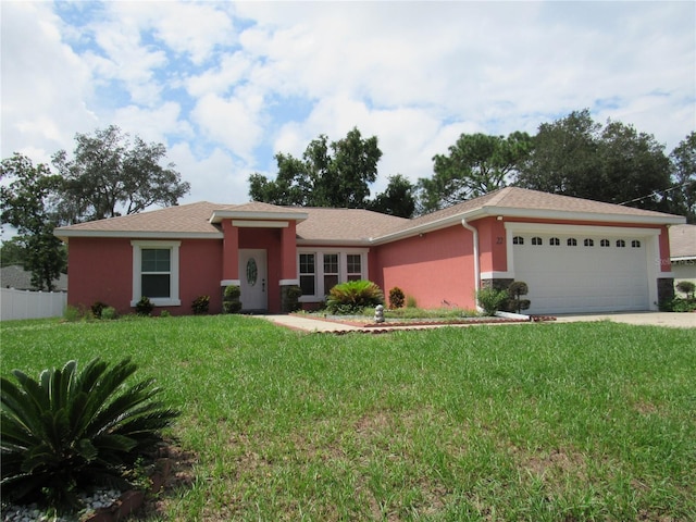 ranch-style house featuring a garage and a front lawn