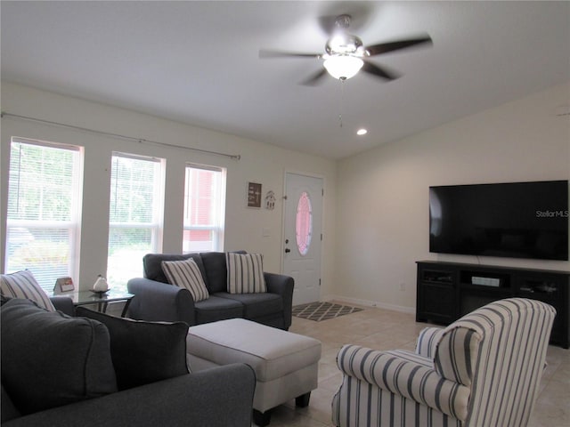 tiled living room with ceiling fan and lofted ceiling