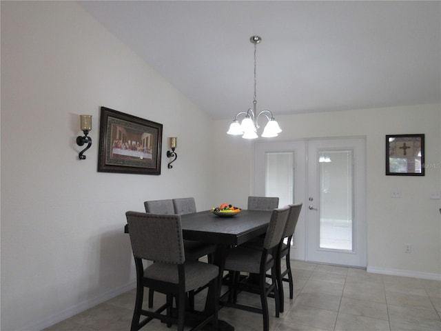 dining room with vaulted ceiling, an inviting chandelier, light tile patterned floors, and french doors