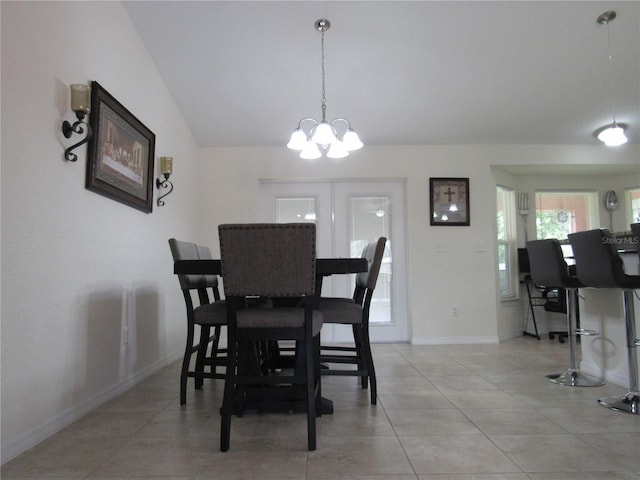 dining area featuring light tile patterned flooring and a chandelier