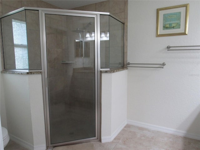 bathroom featuring an enclosed shower, toilet, and tile patterned floors