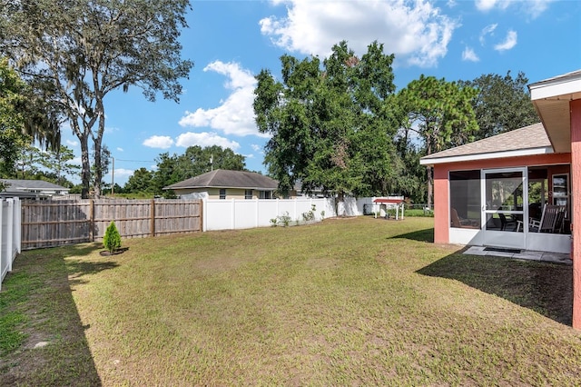 view of yard featuring a sunroom