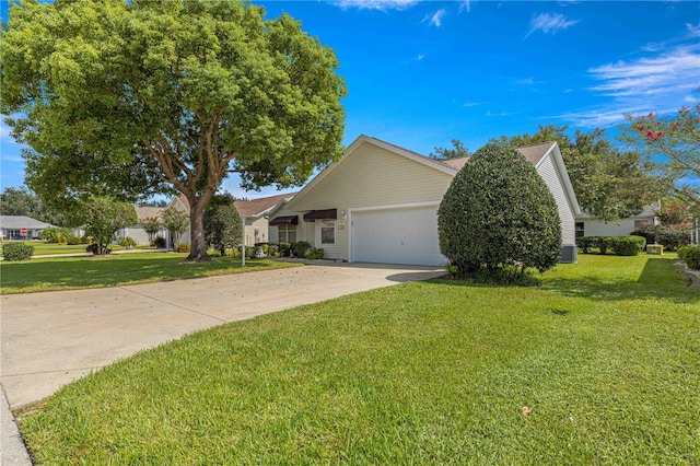 view of side of property with a yard, a garage, and central AC