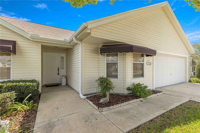 doorway to property featuring a garage