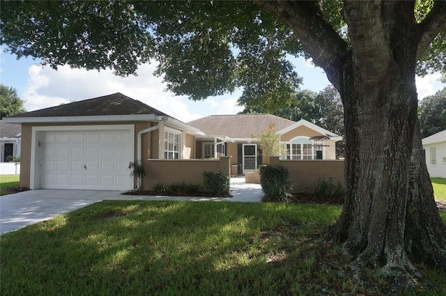 single story home with a garage and a front lawn