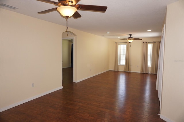 spare room with ceiling fan and dark hardwood / wood-style flooring