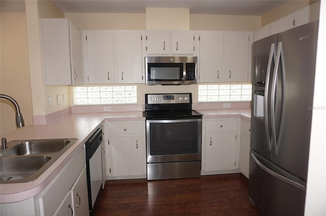 kitchen featuring appliances with stainless steel finishes, a healthy amount of sunlight, and white cabinets