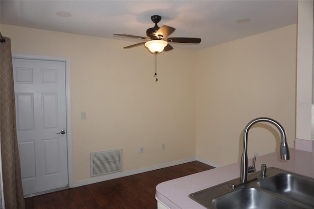 kitchen with ceiling fan, dark wood-type flooring, and sink