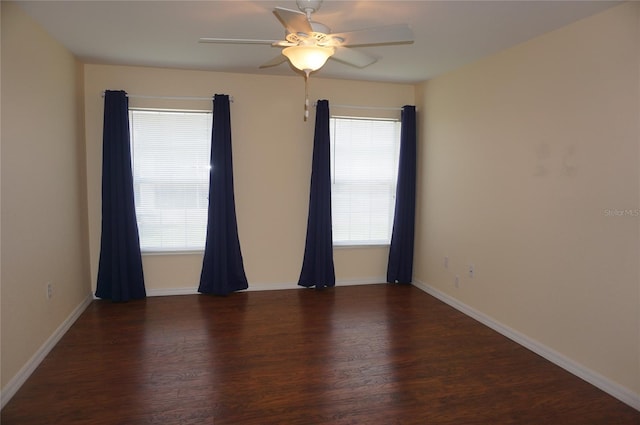 unfurnished room with dark hardwood / wood-style flooring, ceiling fan, and a wealth of natural light