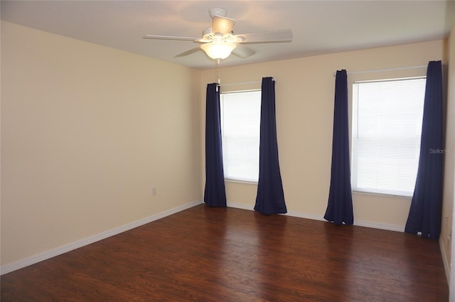 unfurnished room with ceiling fan, dark hardwood / wood-style floors, and a healthy amount of sunlight