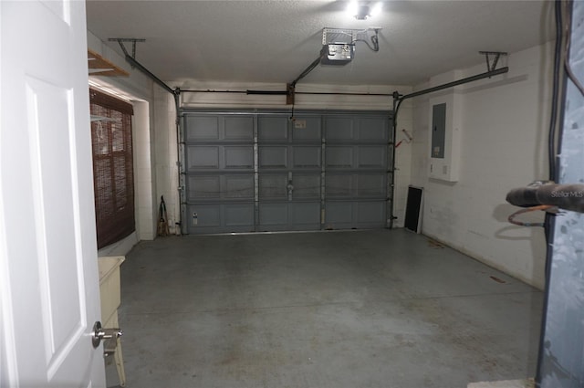 garage with a garage door opener and electric panel