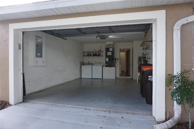 garage with washer and clothes dryer, electric panel, and heating unit