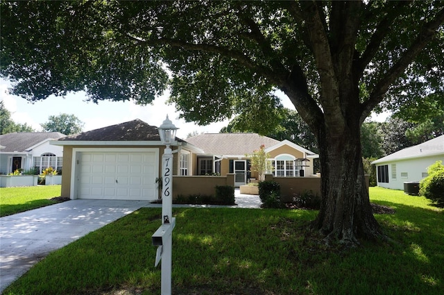 ranch-style house with a garage, a front lawn, and central AC unit